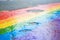 Rainbow Drawn on Wet City Asphalt