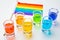 Rainbow drink. Glass shot of alcohol liquor. Bar counter. Rainbow colors. Colored vodka. LGBT Pride. Rainbow flag