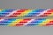 Rainbow dyed braided cords isolated on gray