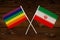 Rainbow flag LGBT and flag of Iran on beautiful brown background with wooden texture. LGBT Pride Month. LGBTQ. LGBTQIA