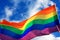 Rainbow flag LGBT movement on the sky background