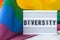 Rainbow flag with lightbox and text DIVERSITY. Rainbow lgbtq flag made from silk material. Symbol of LGBTQ pride month