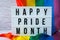 Rainbow flag with lightbox and text HAPPY PRIDE MONTH. Rainbow lgbtq flag made from silk material. Symbol of LGBTQ pride