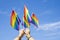 Rainbow flags LGBT community symbol are being waved by a man hands on background clear blue sky