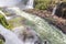 Rainbow, forest, waterfalls and river with rocks