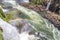 Rainbow, forest, waterfalls and river with rocks