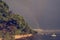 Rainbow forming across the sea after thunder storm.