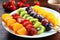 rainbow fruit skewers on a white plate