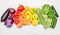 Rainbow fruit and vegetables on white wood