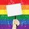 Rainbow  grunge flag. Lgbt colors.Pride month. Hand with protest banner