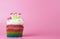 Rainbow heart crown cupcake with pink copy space