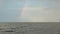 Rainbow on the horizon, filming from the boat, floating on the river