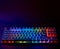 Rainbow keyboard. Gaming keyboard with RGB light. Backlit keyboard in a dark room, copy space