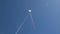 Rainbow kite flying high in blue sky