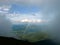 Rainbow between the land and clouds high in Carpathian Mountains