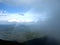 Rainbow between the land and clouds high in Carpathian Mountains