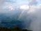 Rainbow between the land and clouds high in Carpathian Mountains