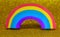 rainbow with the many colors on the golden glitter background