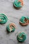 Rainbow meringue kisses, soft peach and mint colors on marble background