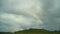 Rainbow in the Mountains and Dramatic landscape. Clouds After the Rain.