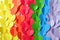 Rainbow of multicolored paper hearts cutouts background