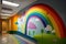 a rainbow mural painted on the wall of a childrens hospital, to brighten the spirits of the young patients.