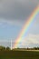 Rainbow near the energy generators at countryside.