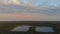 Rainbow in the nice sunset scene over a lake with forest sky