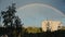 A rainbow over the city, rain and sun