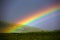 Rainbow over grass filed