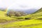 Rainbow Over Green Hills and Meadows in Spring