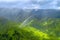 Rainbow over green valley and mountains, aerial view from a helicopter at Na Pali Coast, Kauai, Hawaii