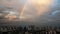 Rainbow over industrial buildings in city after rain. Bangkok city life