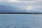 Rainbow over Isabela with shield volcano.