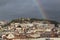 Rainbow over Lisbon city stormy weather