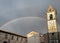 Rainbow over a medieval Catholic church