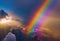 Rainbow over violet purple cloudy sky as panoramic high altitude shot. Dawn early morning sunrise satellite above earth