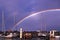Rainbow over waterfront maritime marina/dock with boats