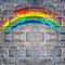 Rainbow painted on stone brick wall