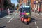 Rainbow painted tuktuk vehicle on a closed off street wih people for Gay Pride Parade