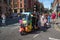 Rainbow painted tuktuk vehicle on a closed off street wih people for Gay Pride Parade