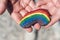 rainbow painting on stone pebble in hand