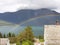 Rainbow panorama lanscape on the beach lake with mountain background with clouds on top