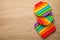 Rainbow pop it fidget toys on wooden table, flat lay. Space for text