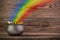 Rainbow pot of gold on old wooden background. St. Patrick`s day symbol