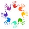 Rainbow prints of children hands in the circle.