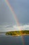 Rainbow in rain during sunshine in sea