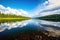 a rainbow reflected on a clear, still lake