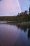 Rainbow reflected in the lake when it rains. on the lake reeds and water lilies