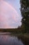 Rainbow reflected in the lake when it rains. on the lake reeds and water lilies